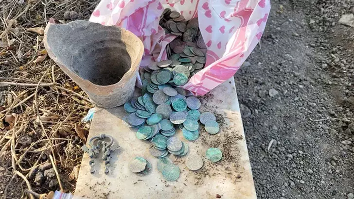 More than 500 coins found during grave excavation